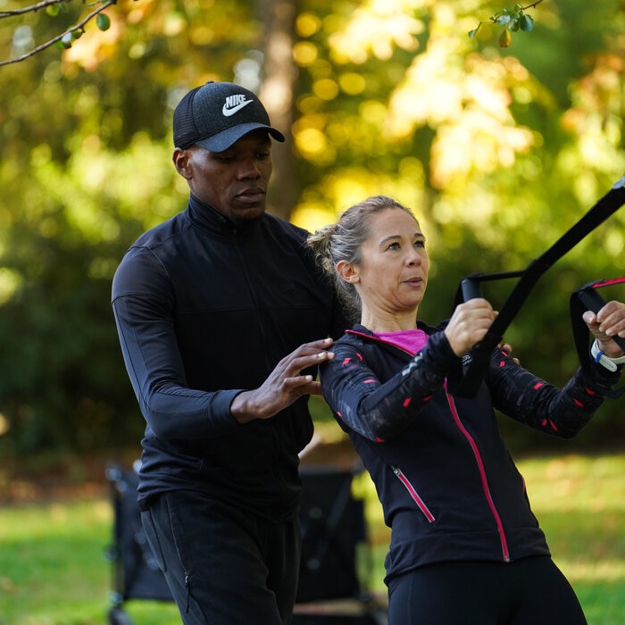 Un coach sportif "ElieB Coaching" guide une femme lors d'une séance de sport en plein air à Angers.